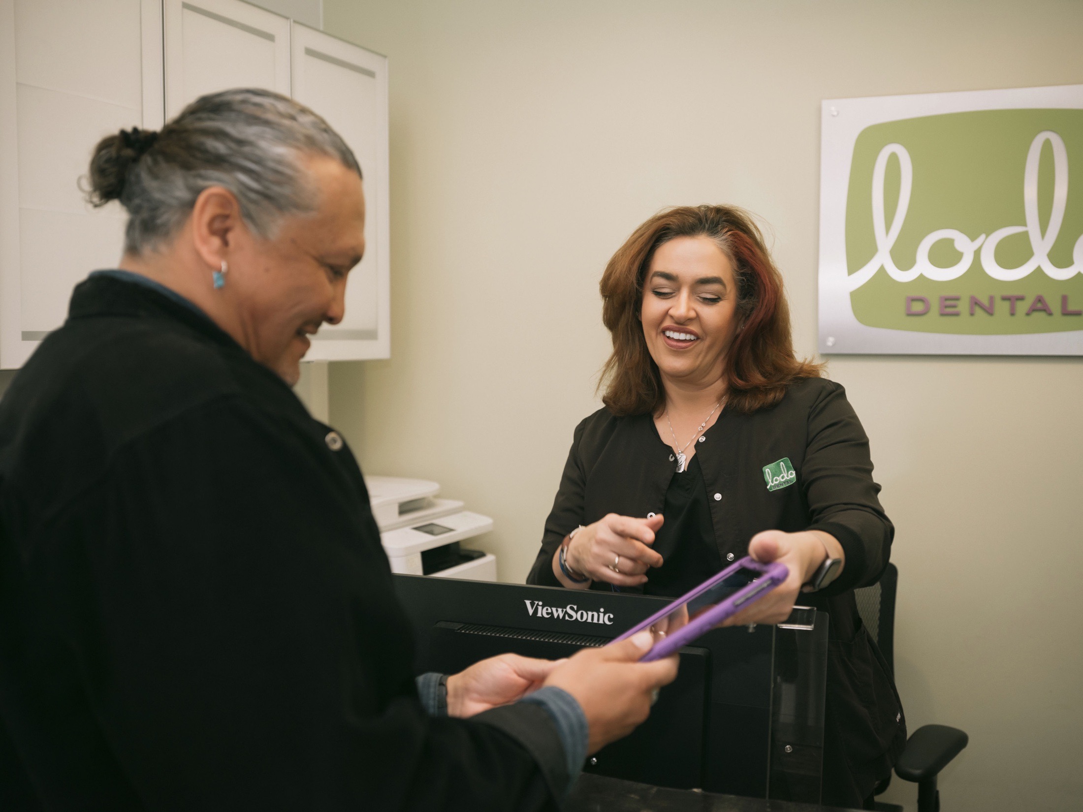 A Lodo Dental team member reviewing details with a patient
